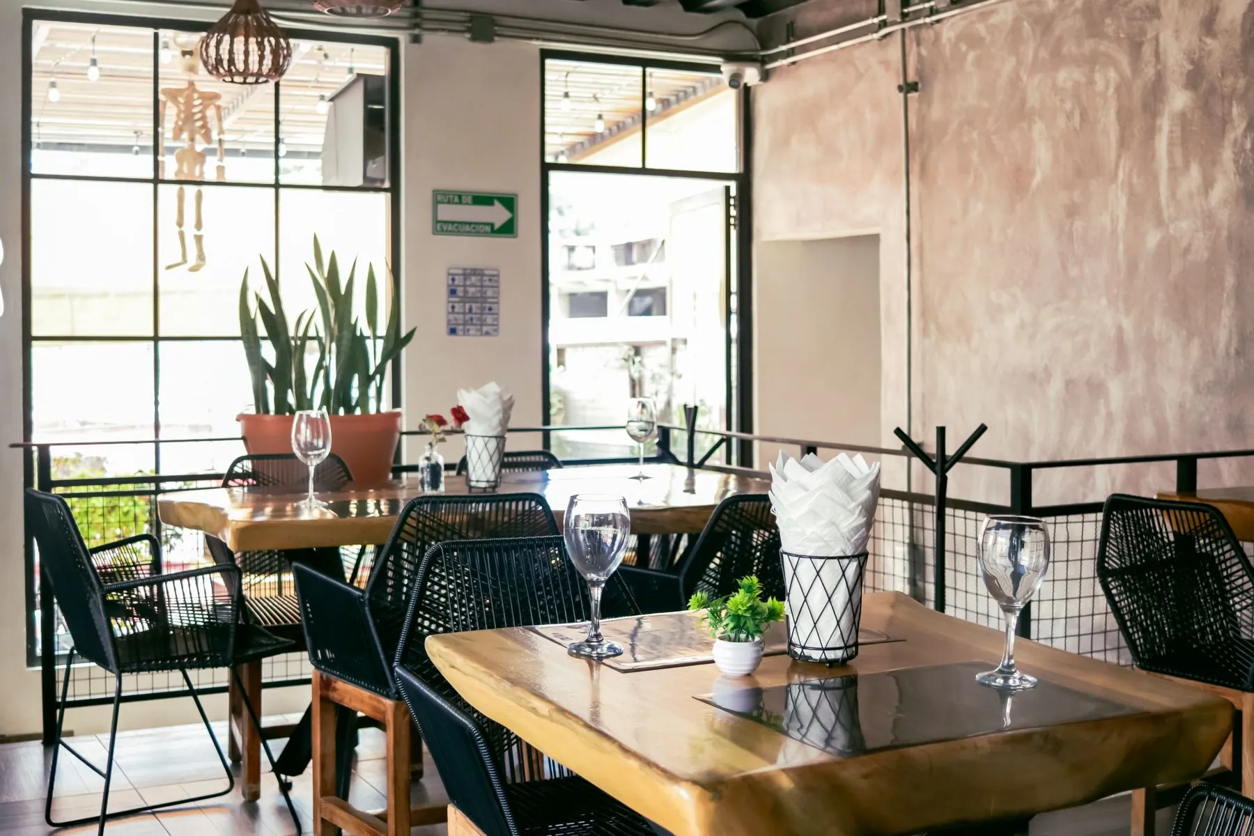 Warm dining room with wooden tables set for service
