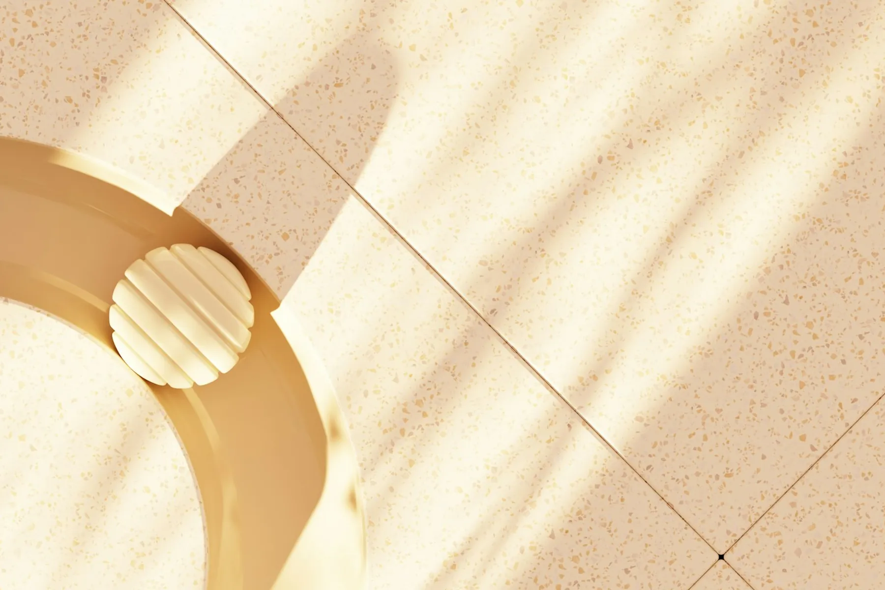 Beige curved sculpture resting on terrazzo tiles in soft sunlight